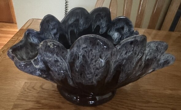 Footed Anna Van Briggle petal bowl in a black to silvery blue high-gloss drip glaze