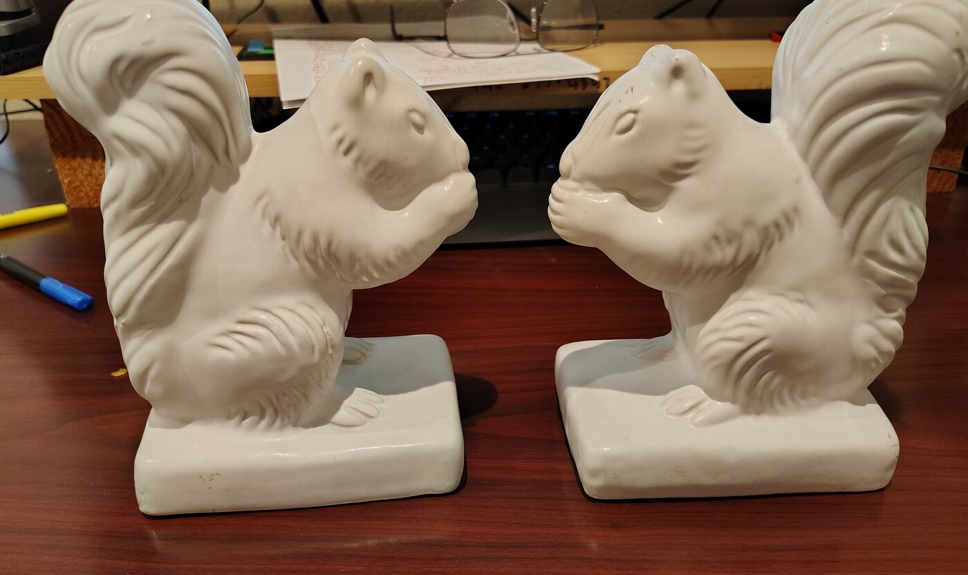 Pair of late commercial Van Briggle squirrel bookends finished in glossy white Moonglo glaze on buff clay